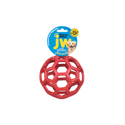 A pink dog ball toy with holes, hanging on a label tag with a dog.